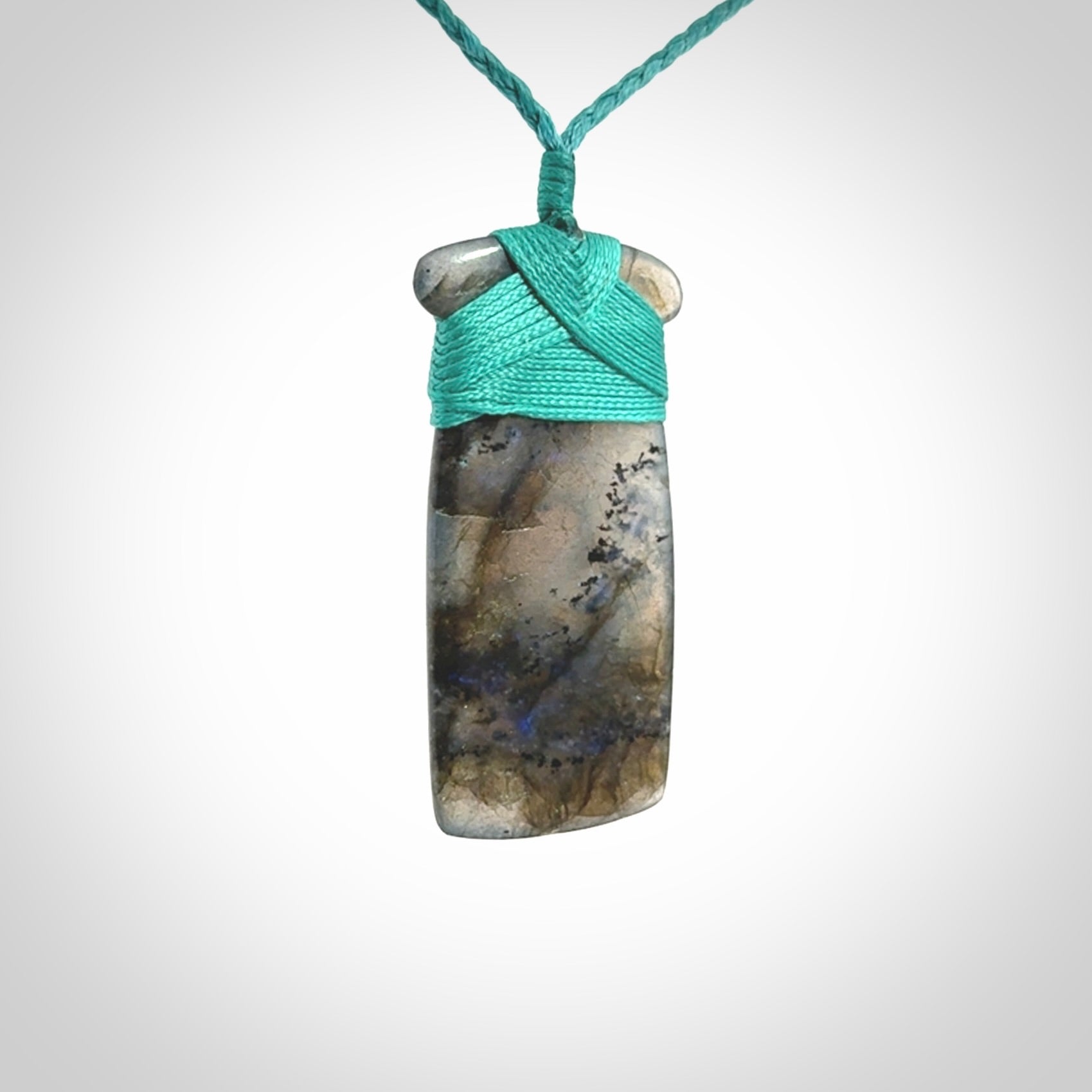 This picture shows a Labradorite stone toki pendant that we have hand carved.