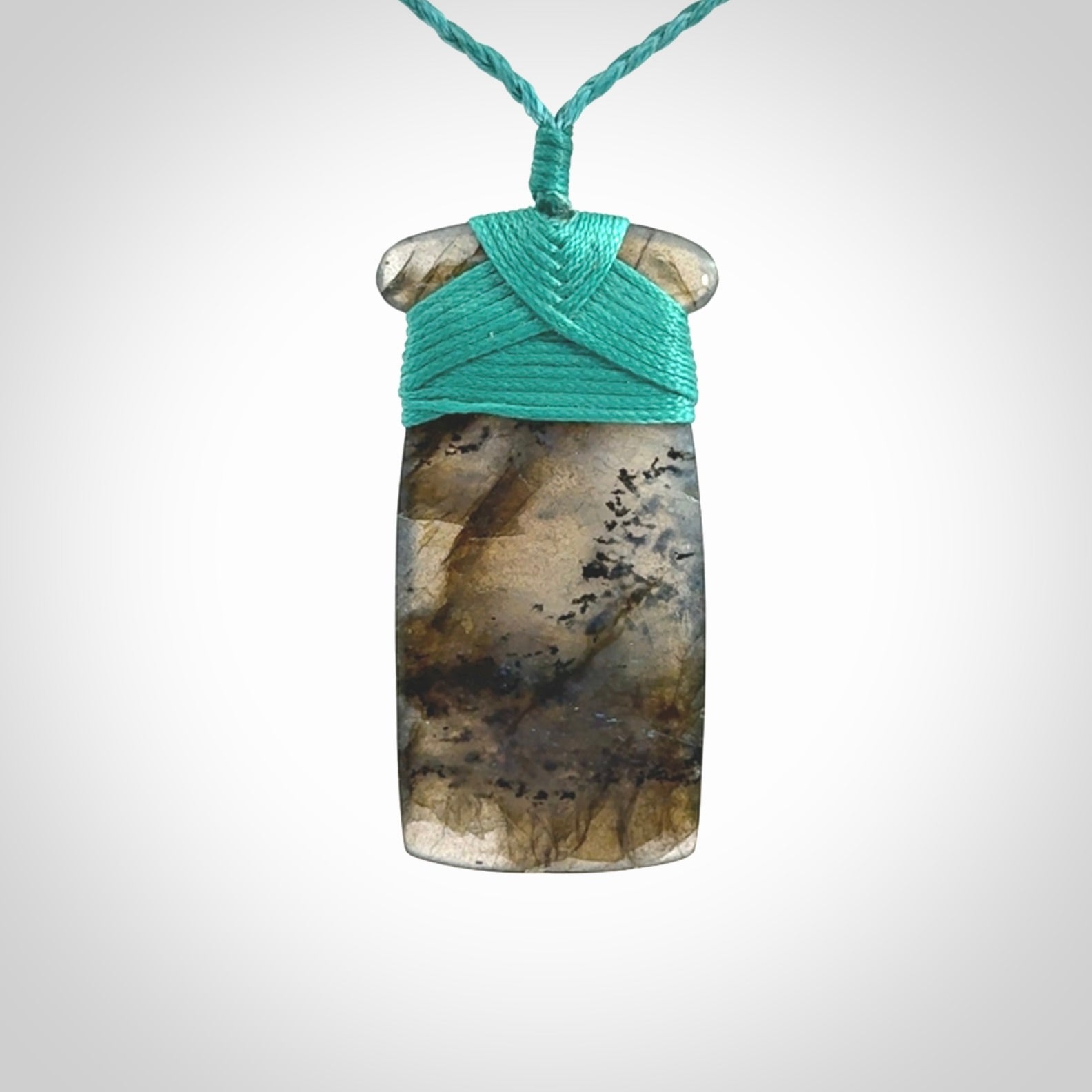 This picture shows a Labradorite stone toki pendant that we have hand carved.