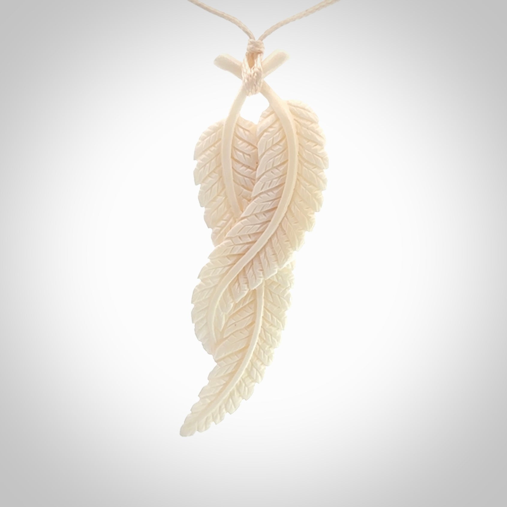 A hand carved large bone double fern leaf necklace. A beautiful large double fern leaf pendant carved from bone for NZ Pacific. This is a true piece of wearable art and is provided with an adjustable cord.