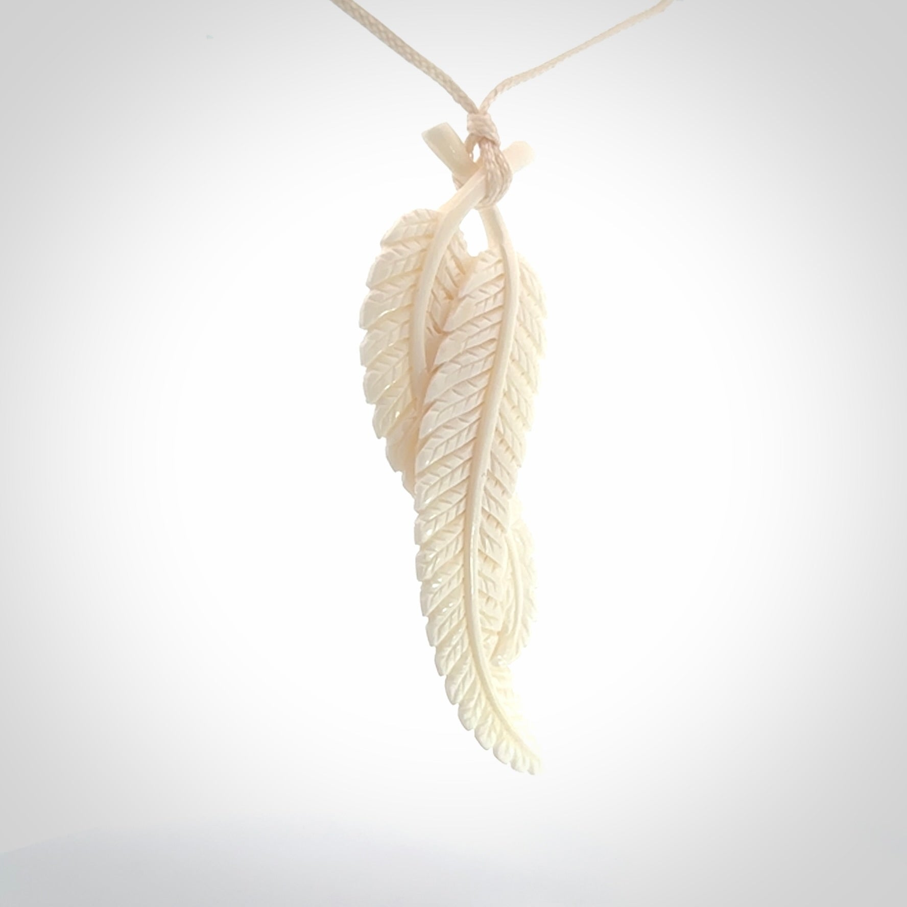 A hand carved large bone double fern leaf necklace. A beautiful large double fern leaf pendant carved from bone for NZ Pacific. This is a true piece of wearable art and is provided with an adjustable cord.