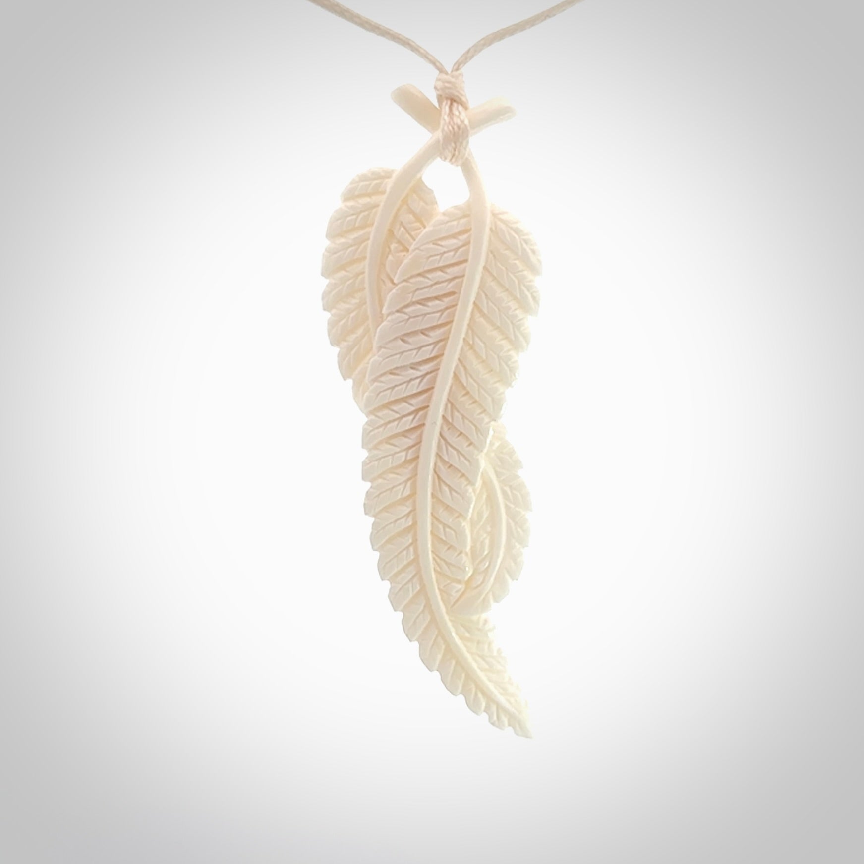 A hand carved large bone double fern leaf necklace. A beautiful large double fern leaf pendant carved from bone for NZ Pacific. This is a true piece of wearable art and is provided with an adjustable cord.
