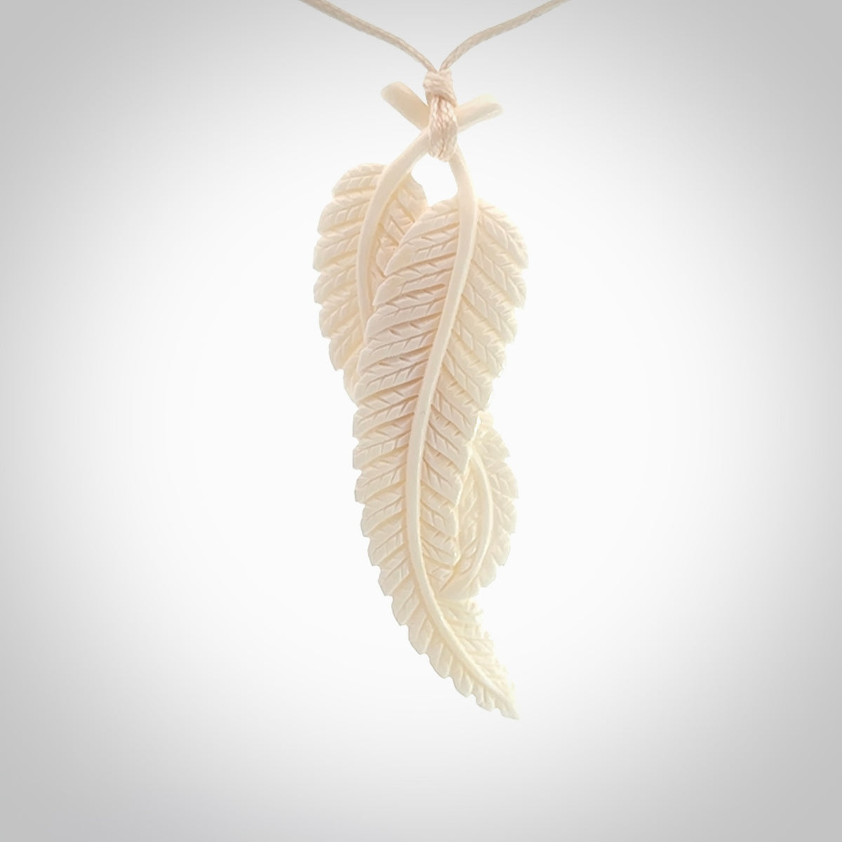 A hand carved large bone double fern leaf necklace. A beautiful large double fern leaf pendant carved from bone for NZ Pacific. This is a true piece of wearable art and is provided with an adjustable cord.