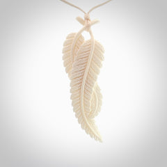A hand carved large bone double fern leaf necklace. A beautiful large double fern leaf pendant carved from bone for NZ Pacific. This is a true piece of wearable art and is provided with an adjustable cord.