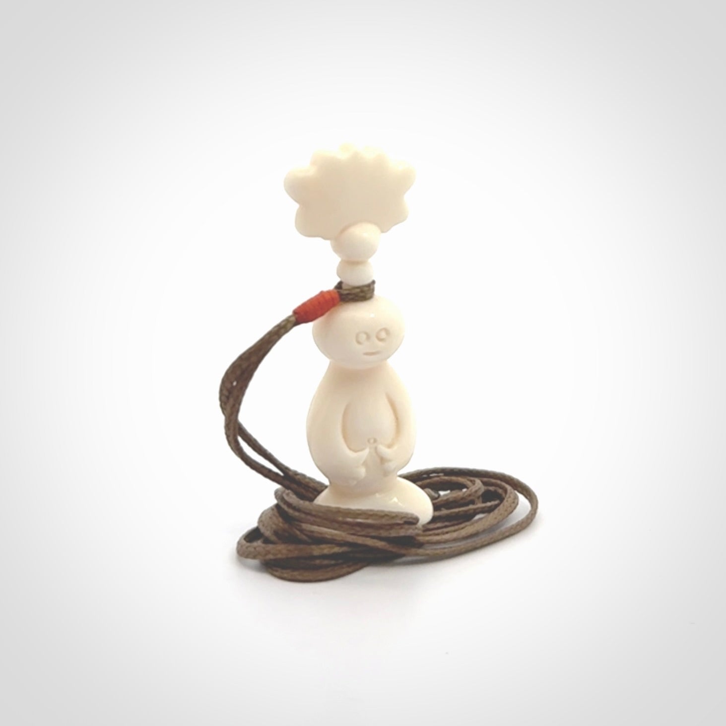 This is a hand carved bone daydreaming character pendant. This is a small-medium sized necklace with adjustable cord.