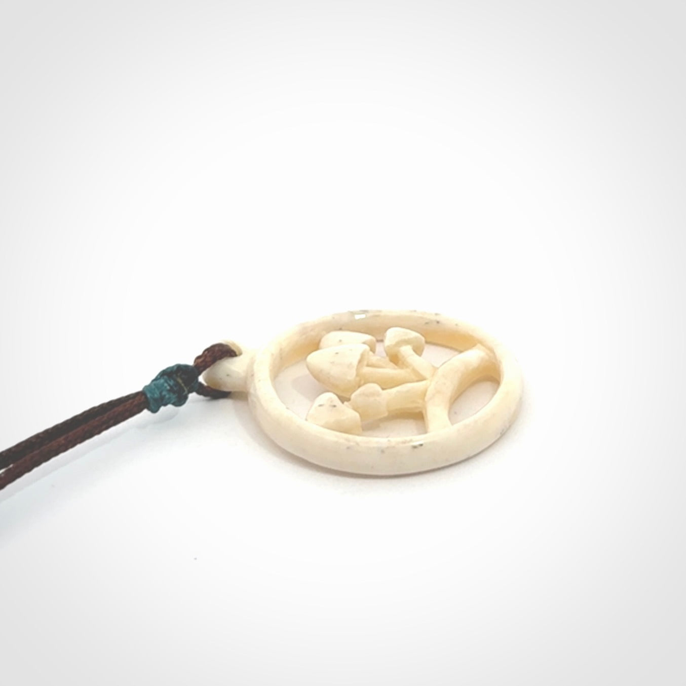 This is a hand carved bone mushroom pendant. This is a smaller sized necklace with adjustable cord.
