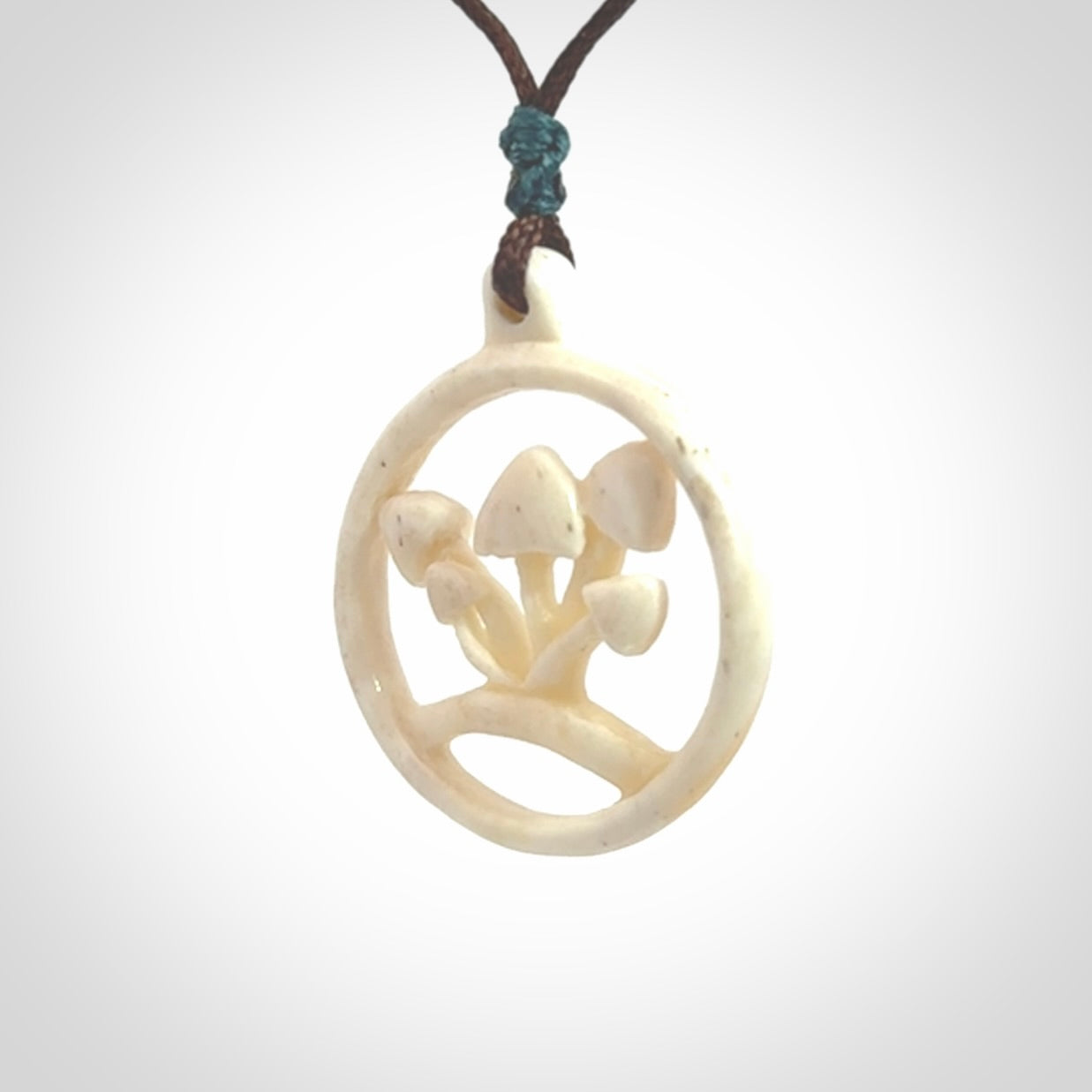This is a hand carved bone mushroom pendant. This is a smaller sized necklace with adjustable cord.