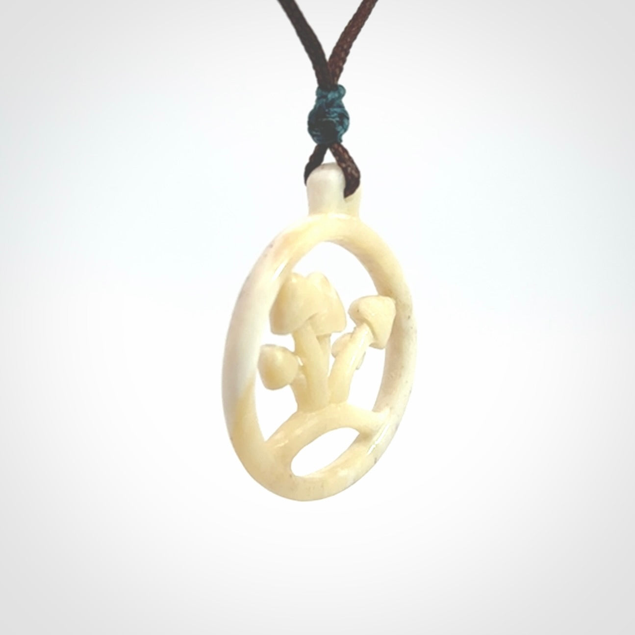 This is a hand carved bone mushroom pendant. This is a smaller sized necklace with adjustable cord.