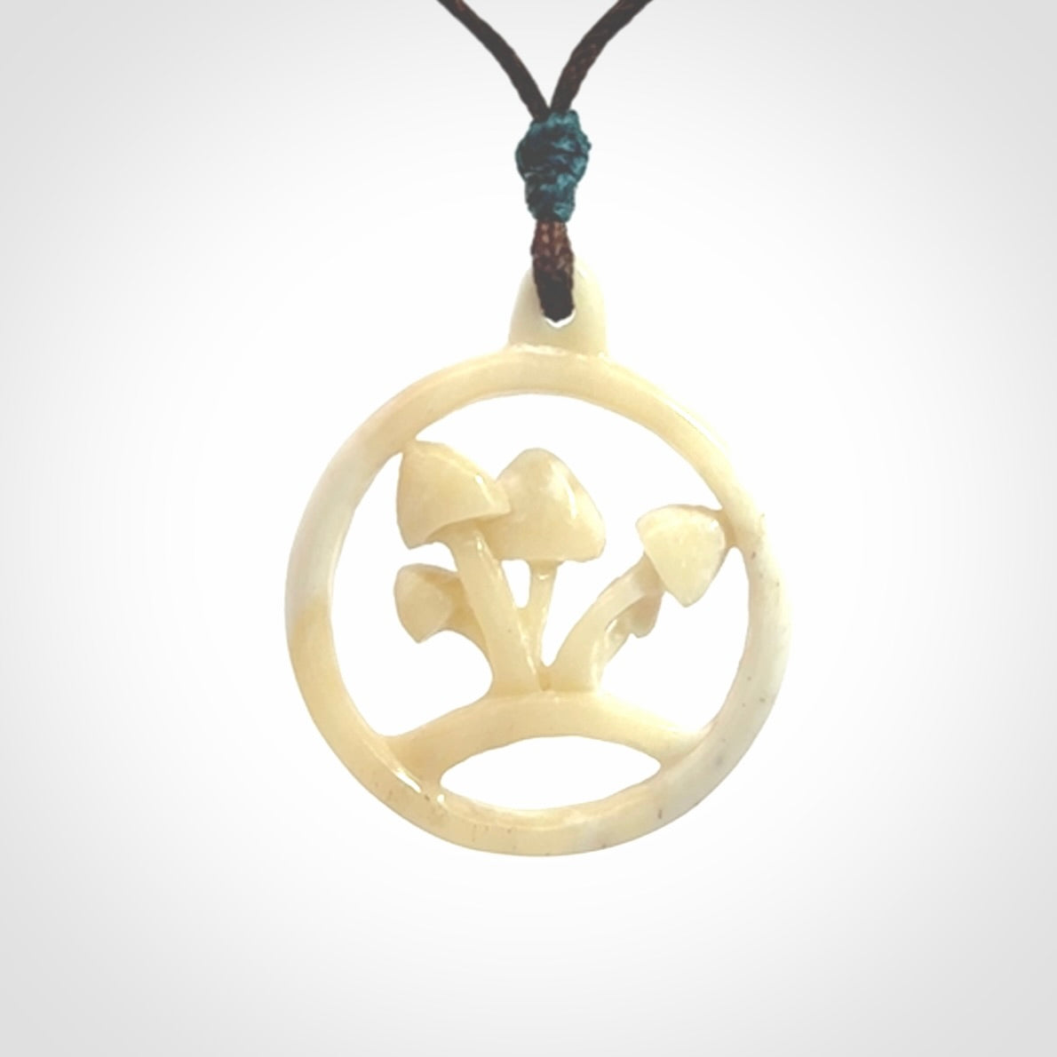 This is a hand carved bone mushroom pendant. This is a smaller sized necklace with adjustable cord.