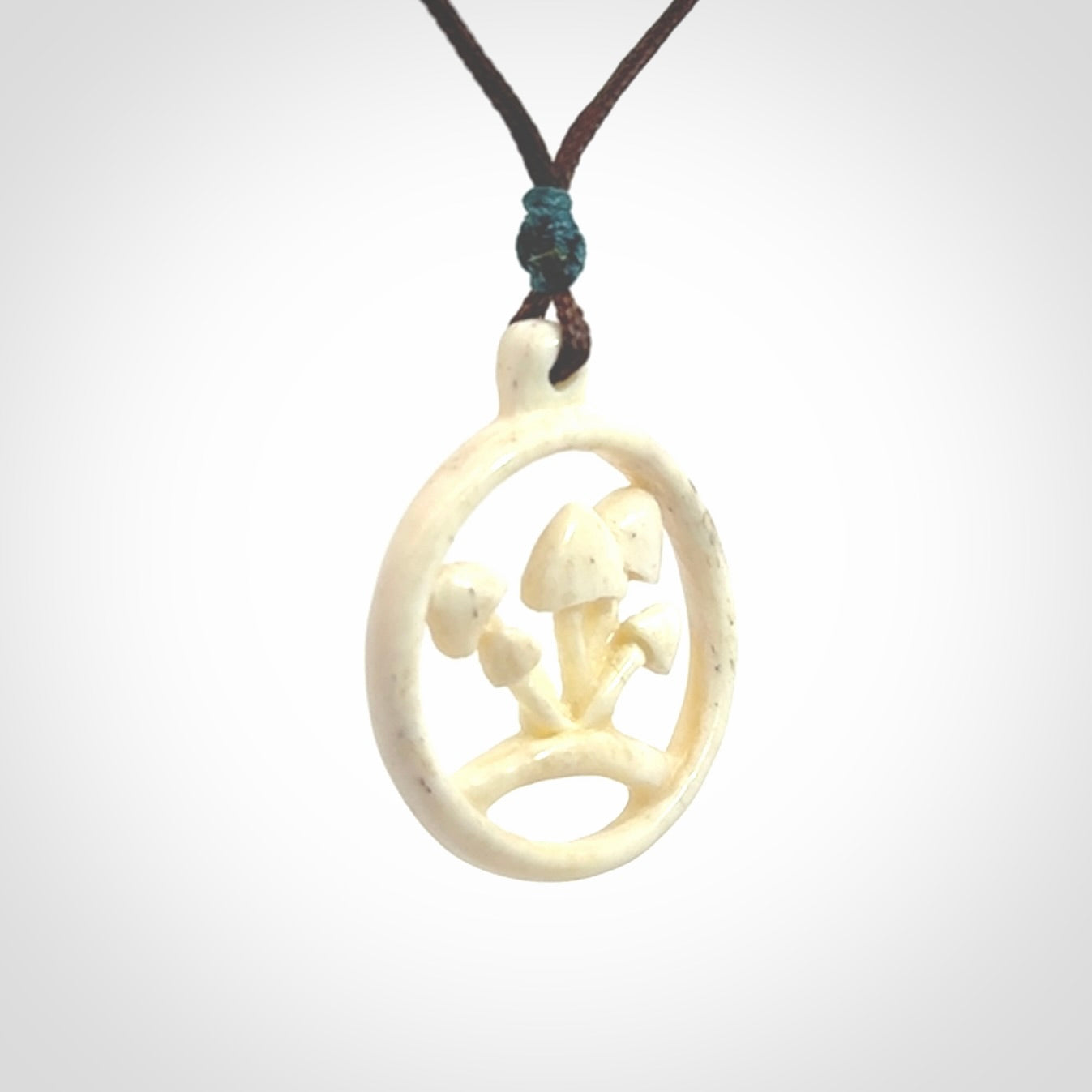 This is a hand carved bone mushroom pendant. This is a smaller sized necklace with adjustable cord.