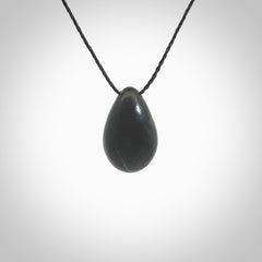 A hand carved baby in the womb pendant made from a jade and bone. This is a work of art carved in jade and bone. We deliver this pendant to you on a plaited cord. Delivery with Express Courier is included in the price.
