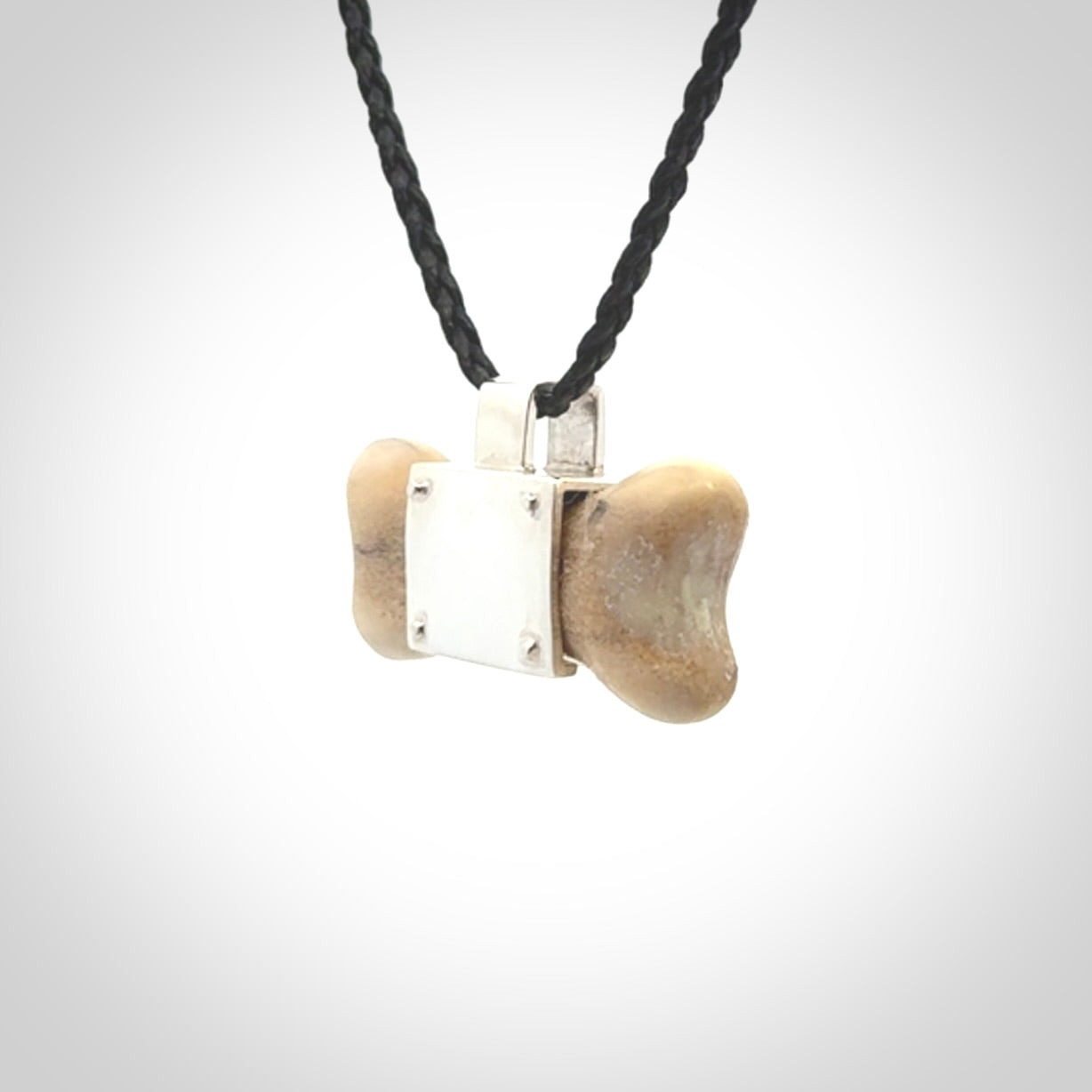 This is a hand carved deer antler dog bone dog tag. It is made from deer antler, bone and sterling silver. Hand made dog tags for your dog.
