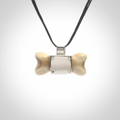 This is a hand carved deer antler dog bone dog tag. It is made from deer antler, bone and sterling silver. Hand made dog tags for your dog.