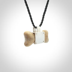 This is a hand carved deer antler dog bone dog tag. It is made from deer antler, bone and sterling silver. Hand made dog tags for your dog.