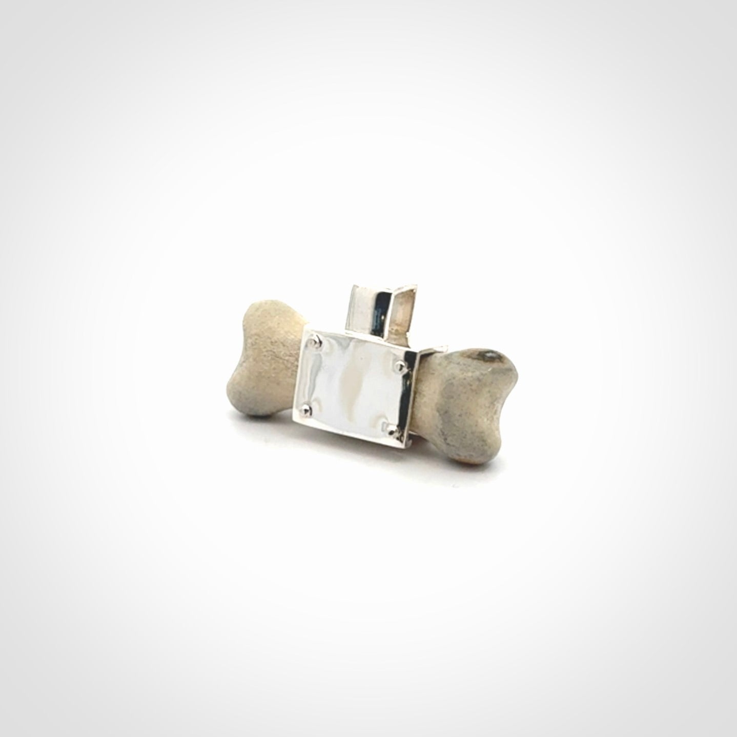 This is a hand carved deer antler dog bone dog tag. It is made from deer antler, bone and sterling silver. Hand made dog tags for your dog.