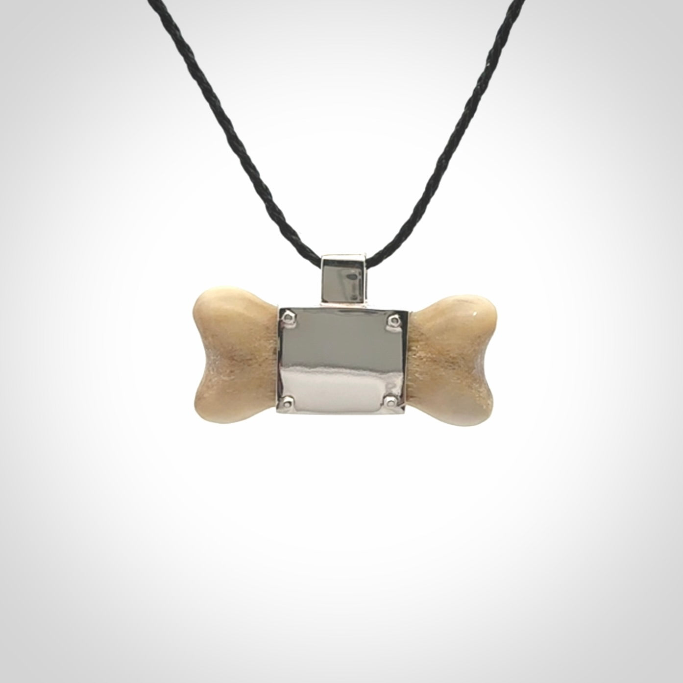This is a hand carved deer antler dog bone dog tag. It is made from deer antler, bone and sterling silver. Hand made dog tags for your dog.