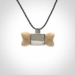 This is a hand carved deer antler dog bone dog tag. It is made from deer antler, bone and sterling silver. Hand made dog tags for your dog.