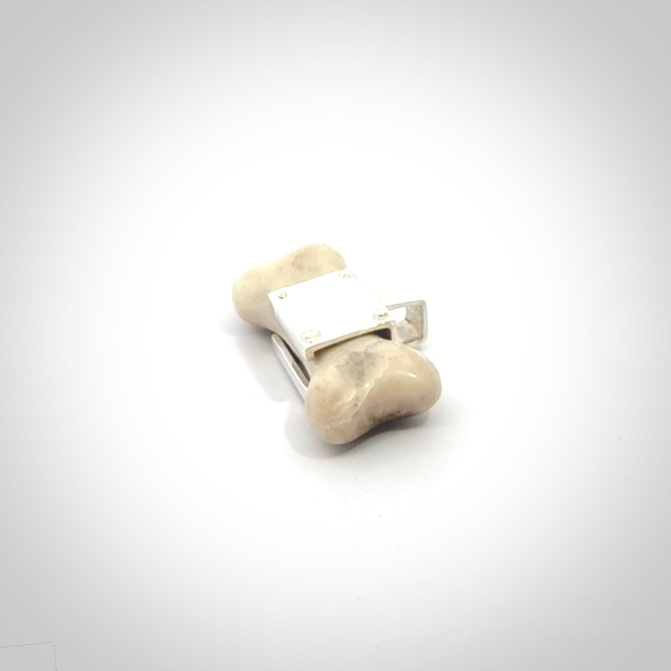 This is a hand carved deer antler dog bone dog tag. It is made from deer antler, bone and sterling silver. Hand made dog tags for your dog.