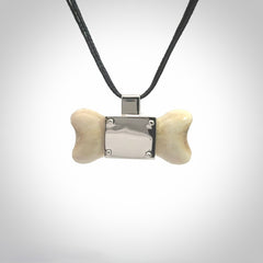 This is a hand carved deer antler dog bone dog tag. It is made from deer antler, bone and sterling silver. Hand made dog tags for your dog.