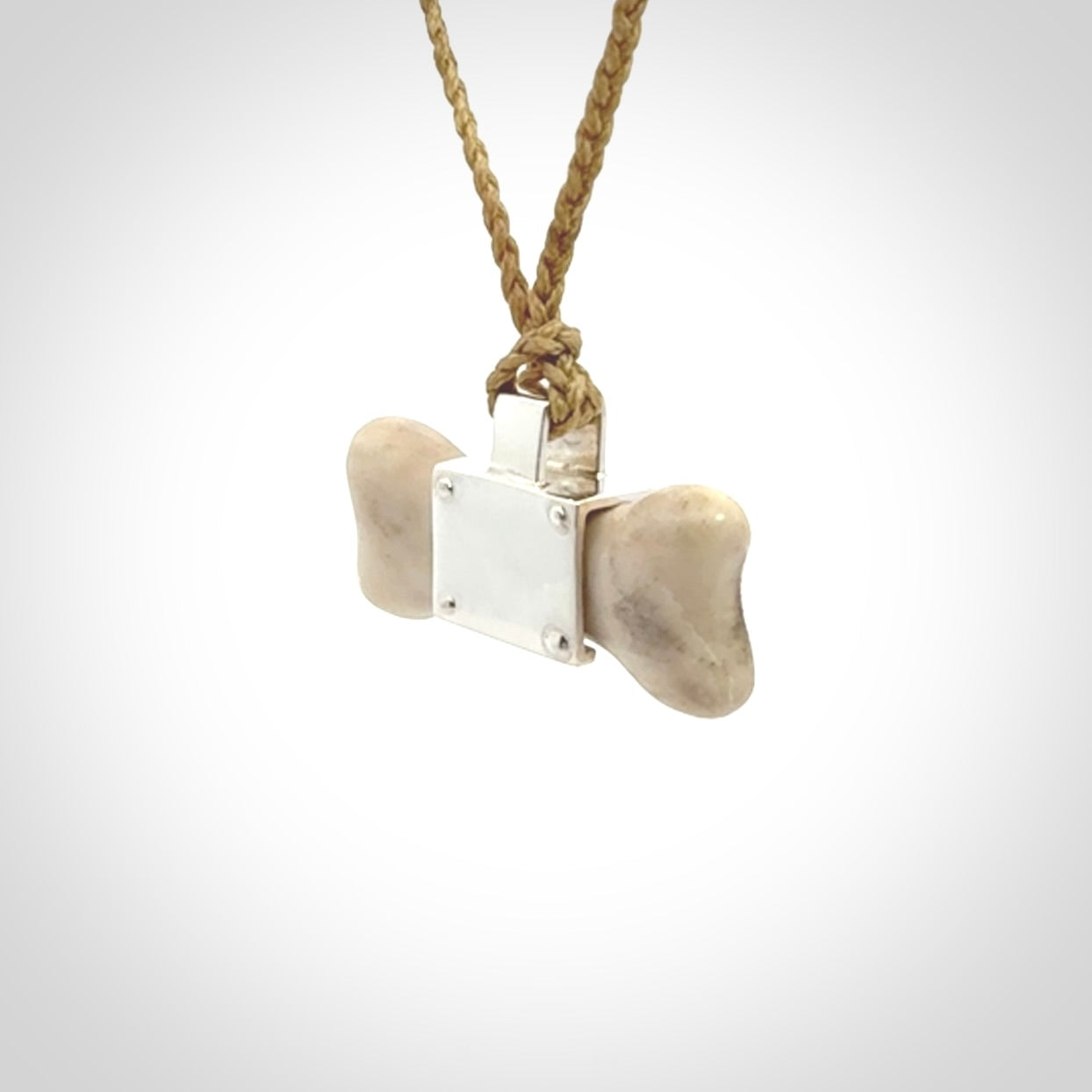 This is a hand carved deer antler dog bone dog tag. It is made from deer antler, bone and sterling silver. Hand made dog tags for your dog.