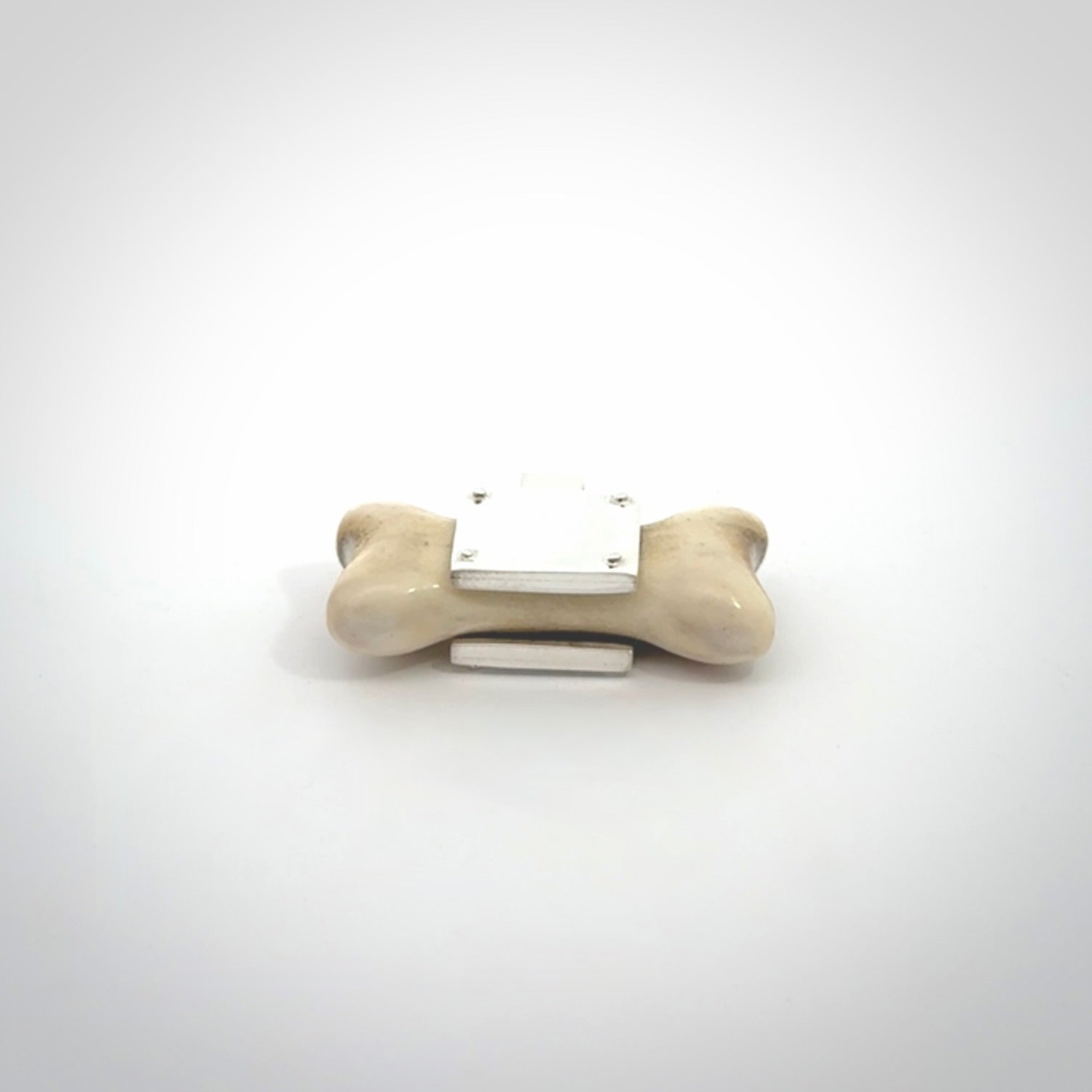 This is a hand carved deer antler dog bone dog tag. It is made from deer antler, bone and sterling silver. Hand made dog tags for your dog.