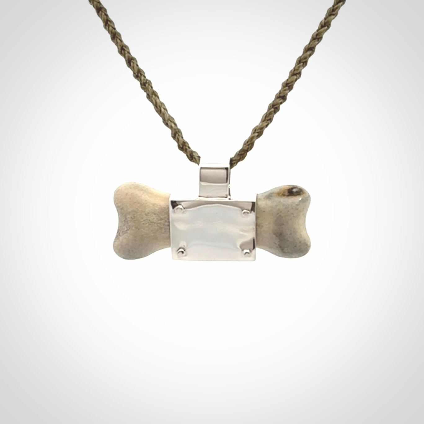 This is a hand carved deer antler dog bone dog tag. It is made from deer antler, bone and sterling silver. Hand made dog tags for your dog.