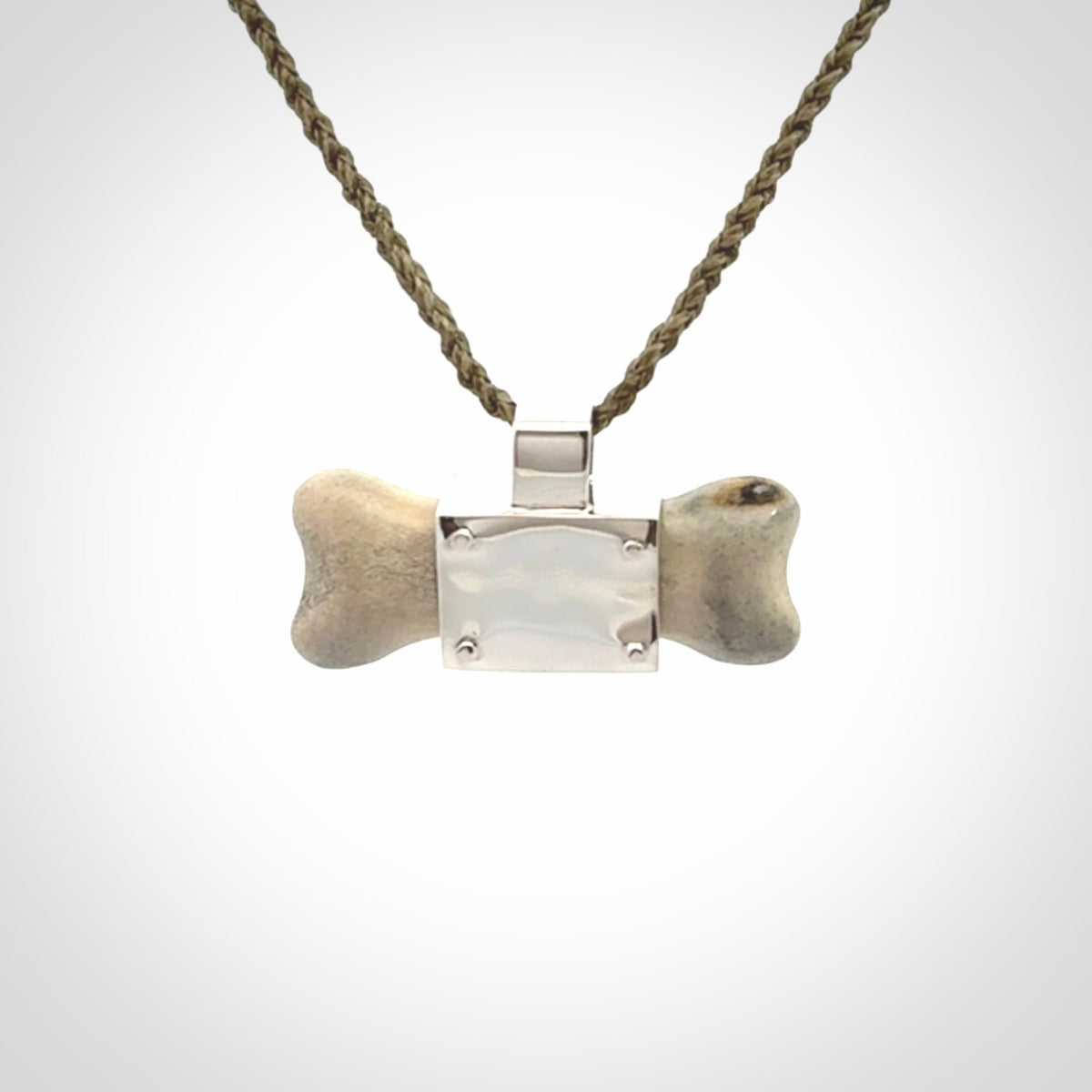 This is a hand carved deer antler dog bone dog tag. It is made from deer antler, bone and sterling silver. Hand made dog tags for your dog.