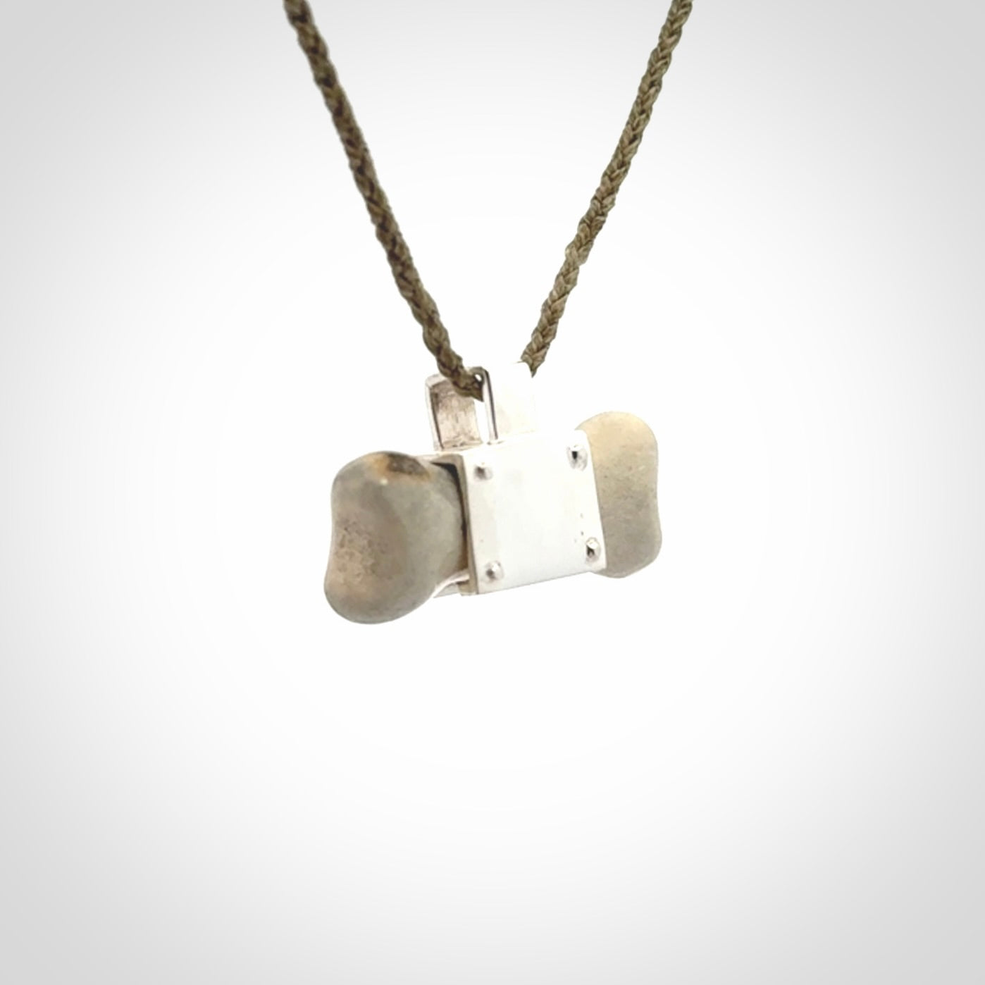 This is a hand carved deer antler dog bone dog tag. It is made from deer antler, bone and sterling silver. Hand made dog tags for your dog.