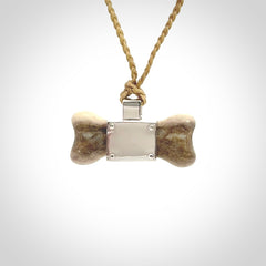 This is a hand carved deer antler dog bone dog tag. It is made from deer antler, bone and sterling silver. Hand made dog tags for your dog.