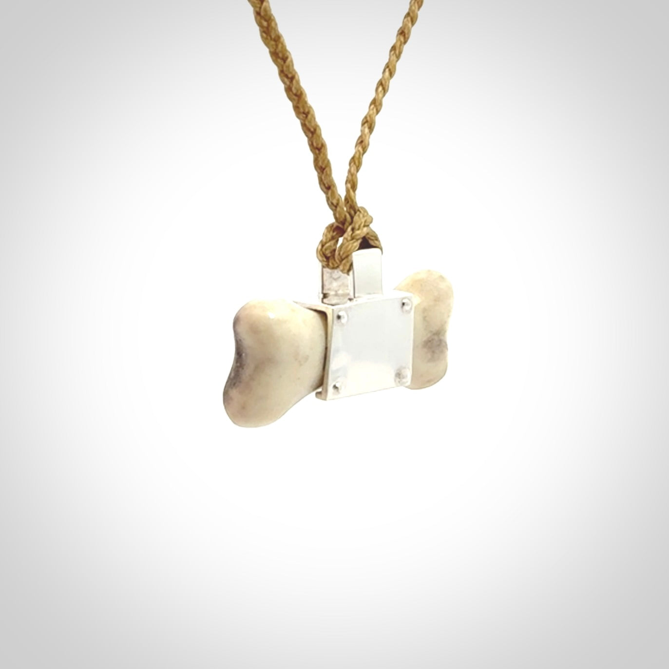 This is a hand carved deer antler dog bone dog tag. It is made from deer antler, bone and sterling silver. Hand made dog tags for your dog.