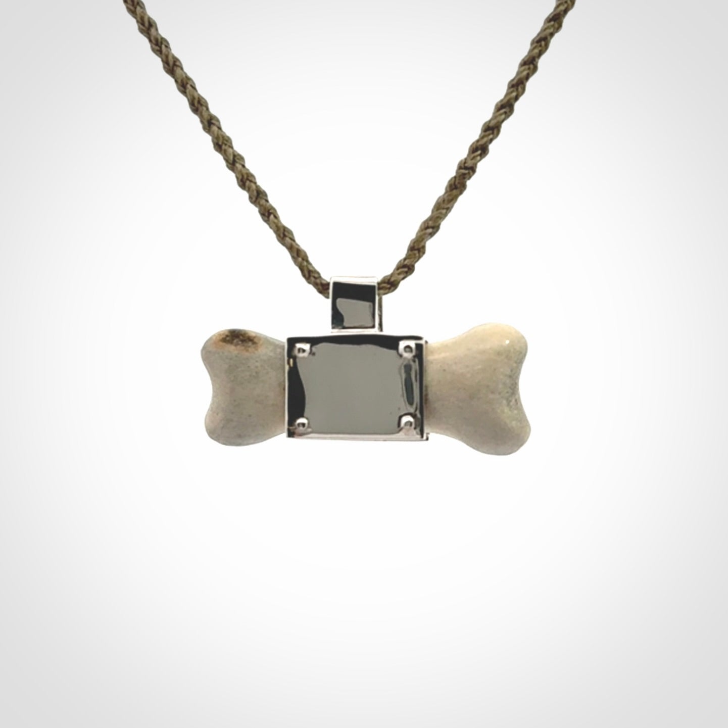 This is a hand carved deer antler dog bone dog tag. It is made from deer antler, bone and sterling silver. Hand made dog tags for your dog.