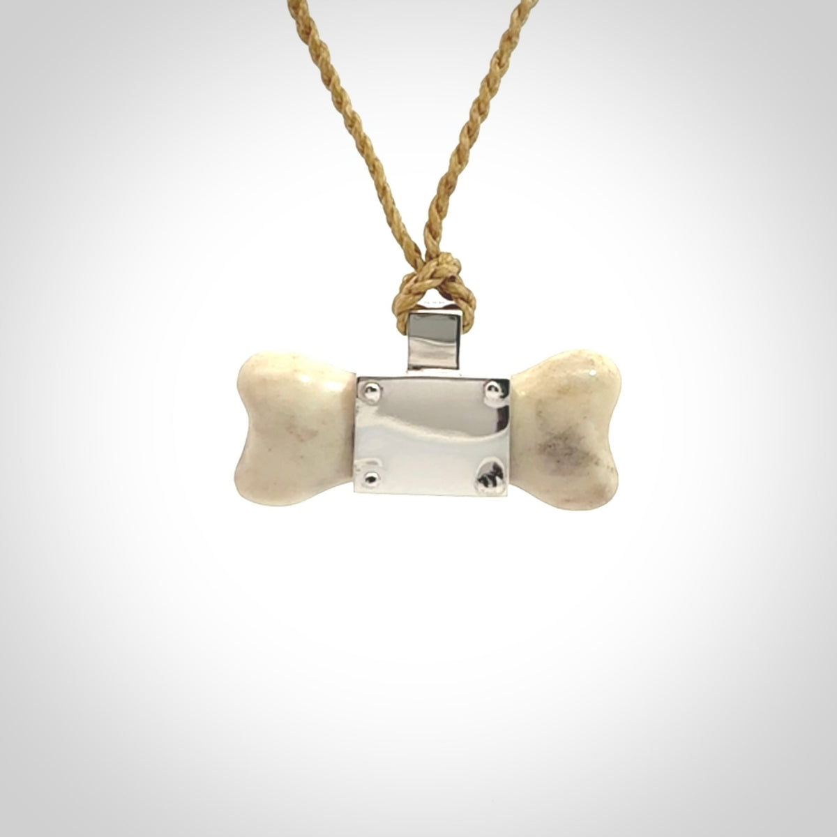 This is a hand carved deer antler dog bone dog tag. It is made from deer antler, bone and sterling silver. Hand made dog tags for your dog.
