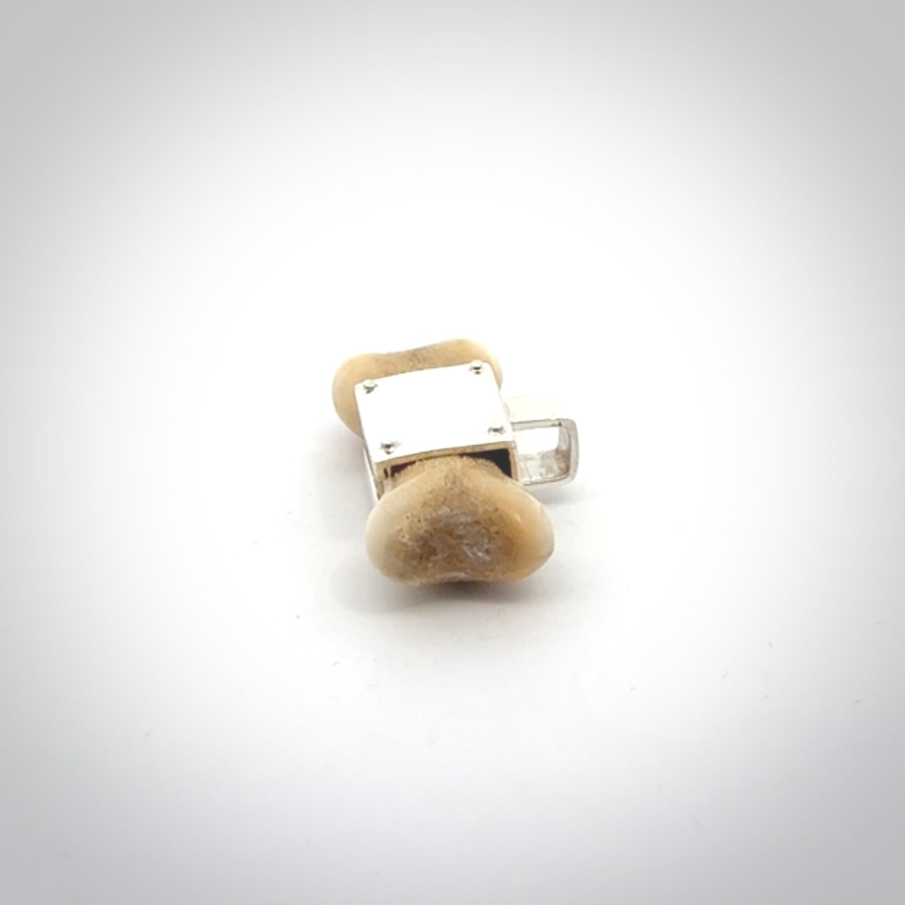 This is a hand carved deer antler dog bone dog tag. It is made from deer antler, bone and sterling silver. Hand made dog tags for your dog.
