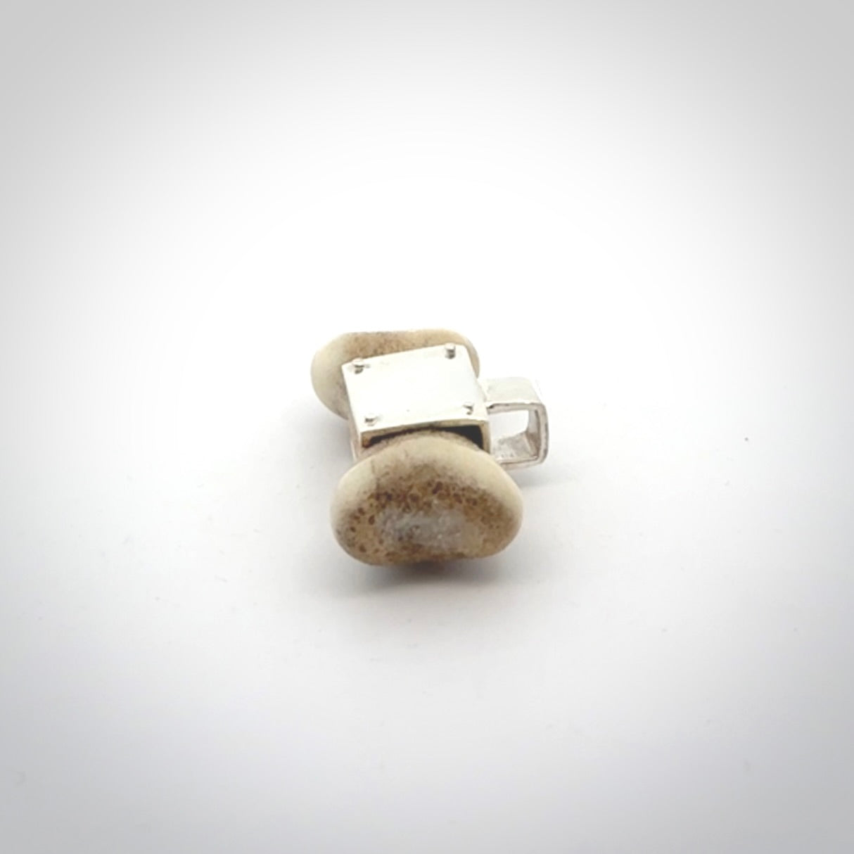 This is a hand carved deer antler dog bone dog tag. It is made from deer antler, bone and sterling silver. Hand made dog tags for your dog.