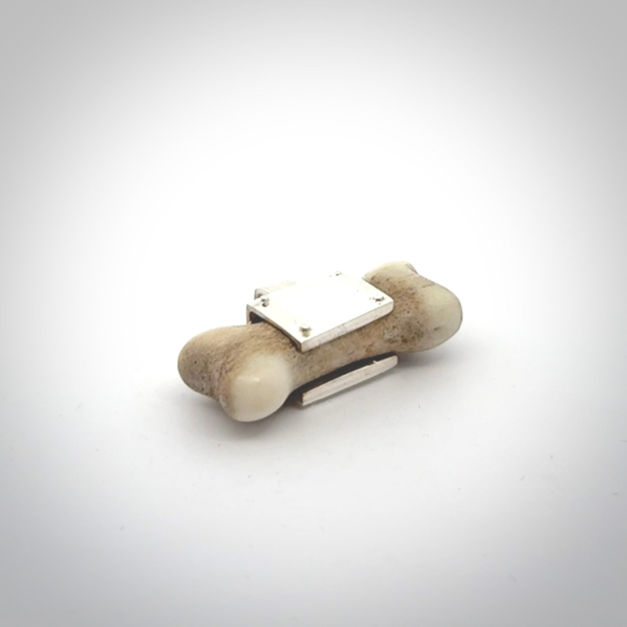 This is a hand carved deer antler dog bone dog tag. It is made from deer antler, bone and sterling silver. Hand made dog tags for your dog.