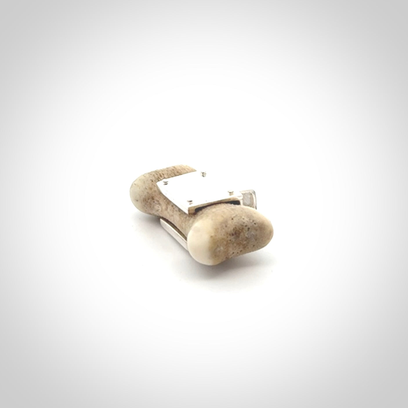 This is a hand carved deer antler dog bone dog tag. It is made from deer antler, bone and sterling silver. Hand made dog tags for your dog.