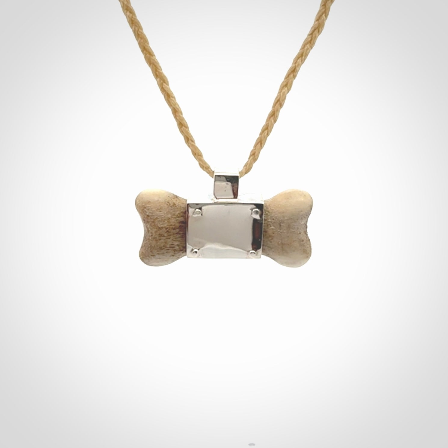 This is a hand carved deer antler dog bone dog tag. It is made from deer antler, bone and sterling silver. Hand made dog tags for your dog.