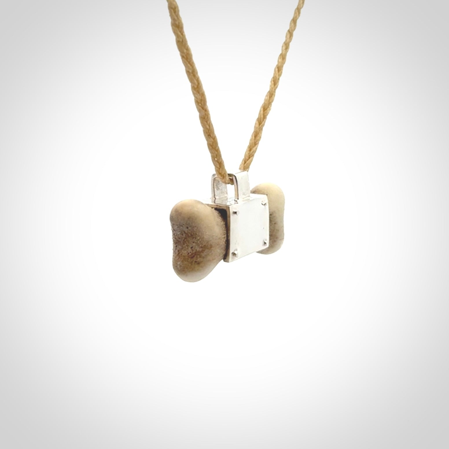 This is a hand carved deer antler dog bone dog tag. It is made from deer antler, bone and sterling silver. Hand made dog tags for your dog.