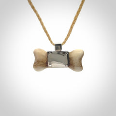 This is a hand carved deer antler dog bone dog tag. It is made from deer antler, bone and sterling silver. Hand made dog tags for your dog.