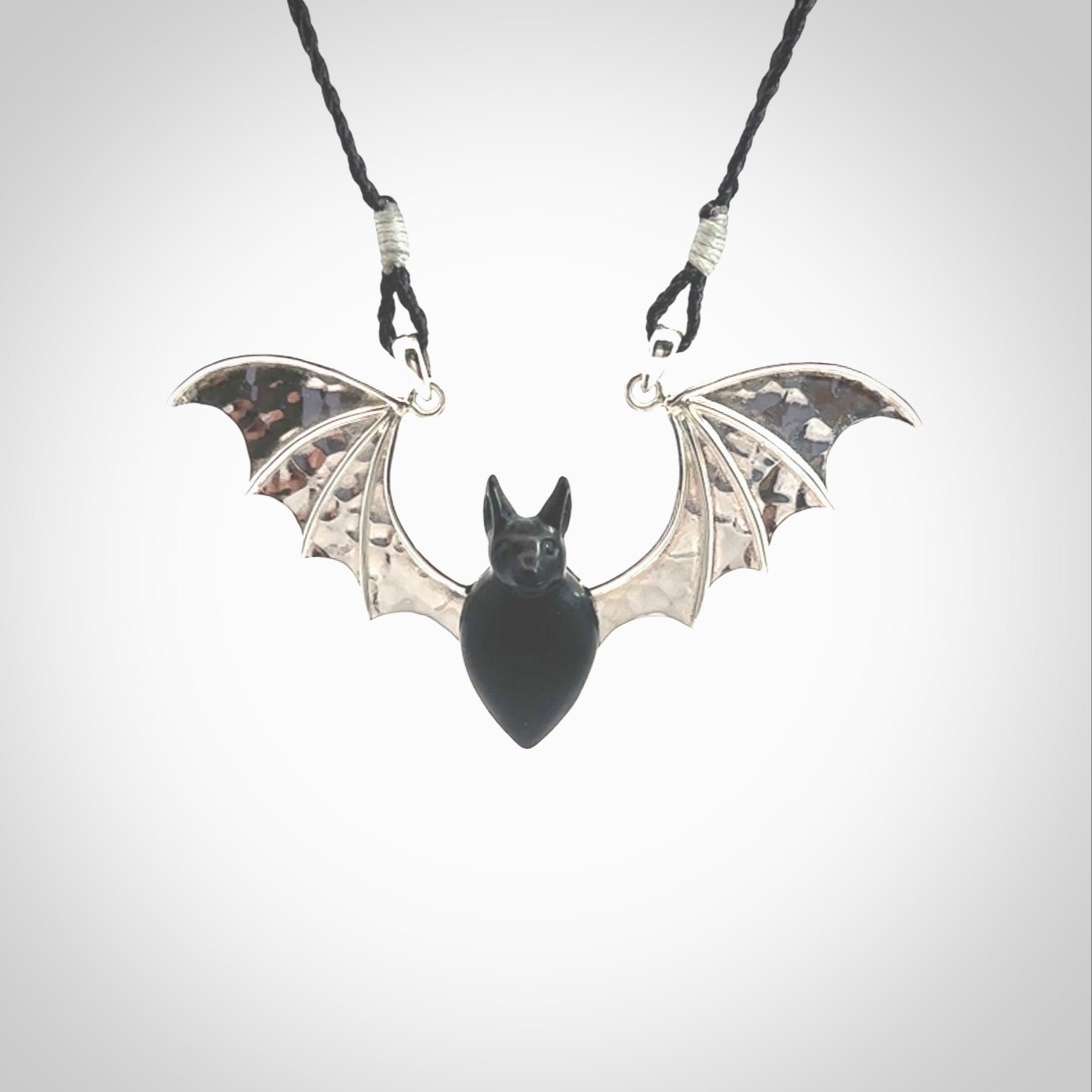 This is a hand carved bat pendant. It is made from Black Jade and Sterling Silver. This is a medium sized necklace and is a very unique, one only, pendant that is a collectors piece. Provided with black adjustable cord.