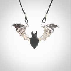 This is a hand carved bat pendant. It is made from Black Jade and Sterling Silver. This is a medium sized necklace and is a very unique, one only, pendant that is a collectors piece. Provided with black adjustable cord.