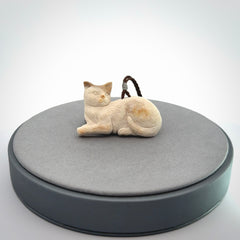 This cat pendant radiates quiet elegance with a regal composure. Hand made in bone.
