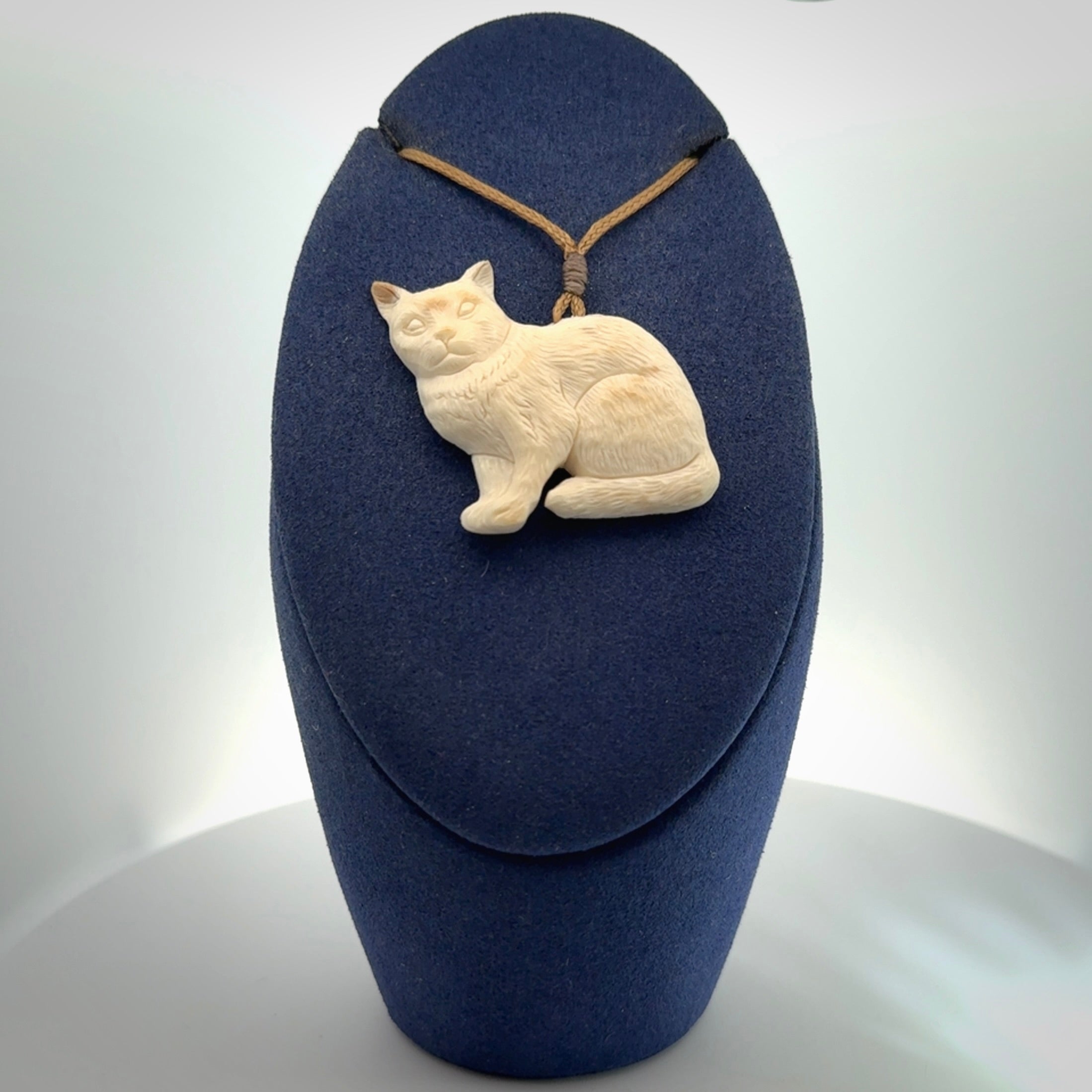 A lovely little cat pendant, hand carved in bone