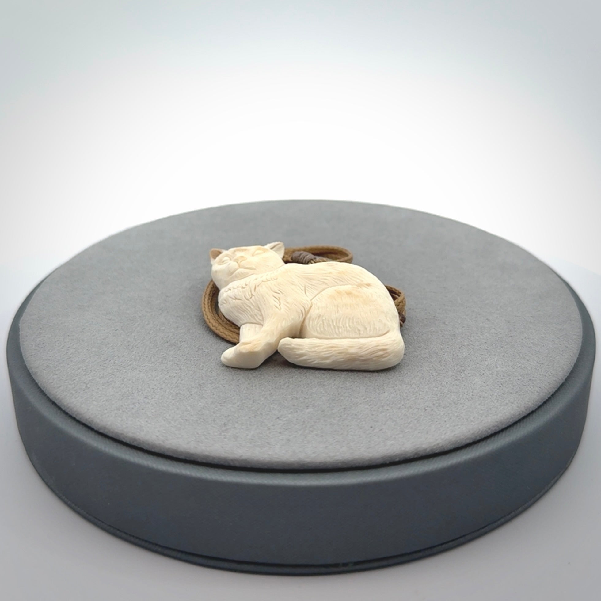 A lovely little cat pendant, hand carved in bone