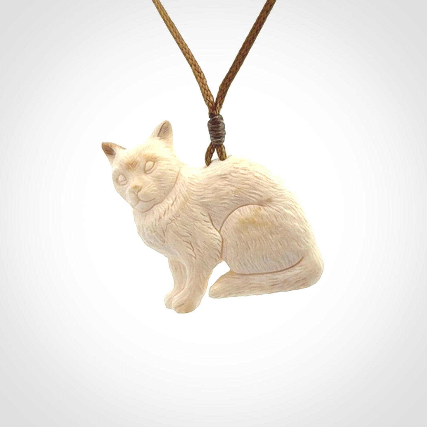 A lovely little cat pendant, hand carved in bone