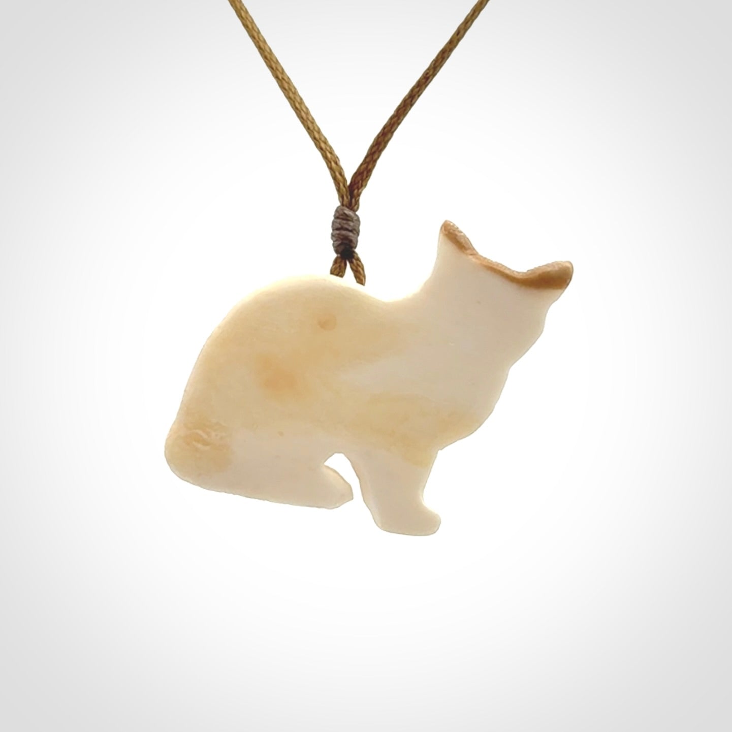 A lovely little cat pendant, hand carved in bone