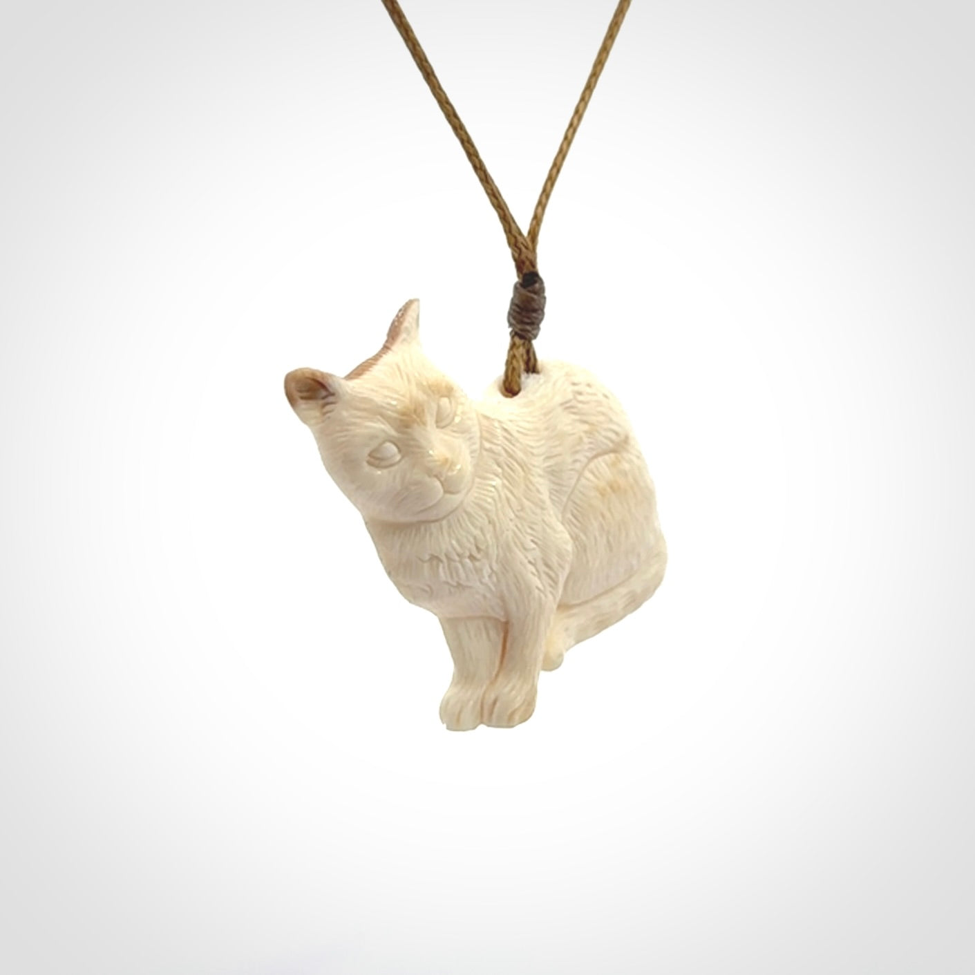 A lovely little cat pendant, hand carved in bone