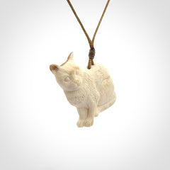 A lovely little cat pendant, hand carved in bone