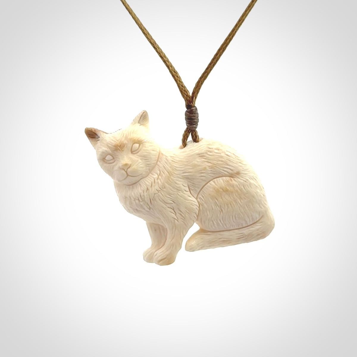 A lovely little cat pendant, hand carved in bone