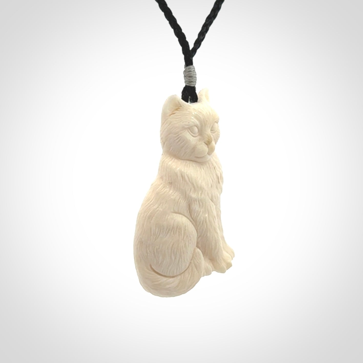 A charismatic cat pendant, hand carved in bone