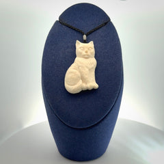 A charismatic cat pendant, hand carved in bone